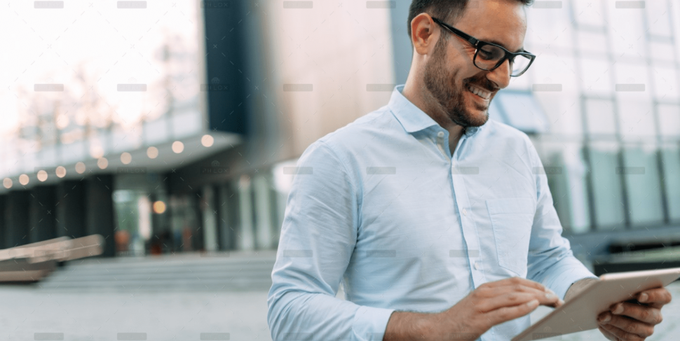 demo-attachment-1806-portrait-of-businessman-in-glasses-holding-tablet-AWVHCJU